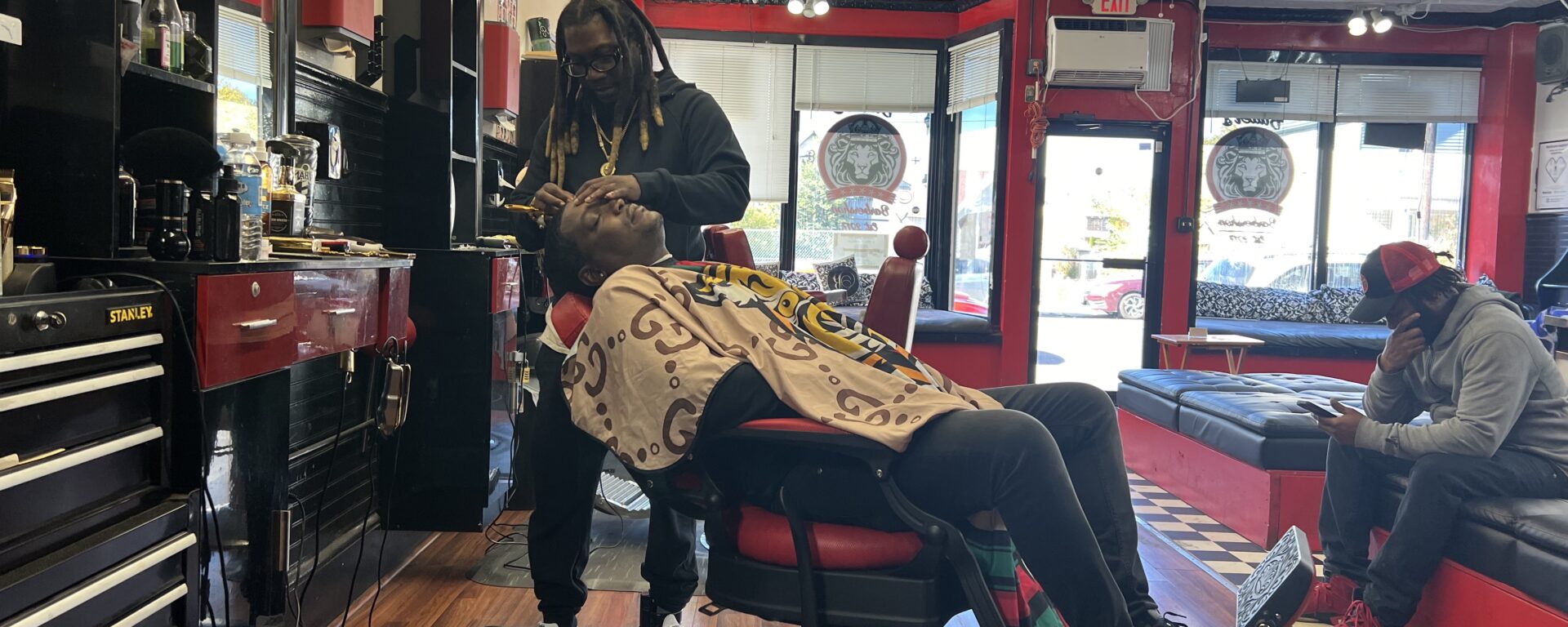 Amar Bell, left, head barber and owner of Butter’s Barbershop & Salon