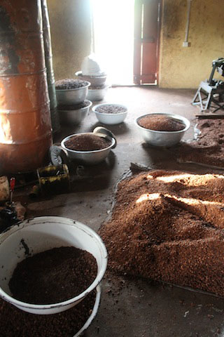 The several states of a Shea nut’s conversion into butter rest by some of the processing machines. A new warehouse would afford the women increased storage space.