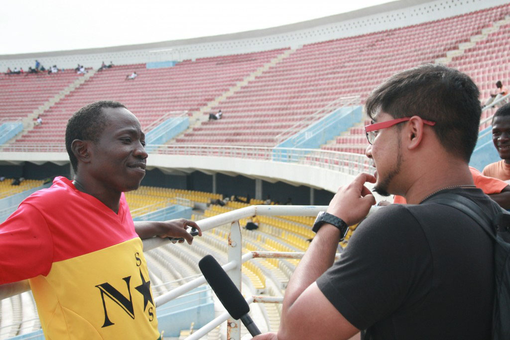 Najid Sultan interviews a supporter of The Black Queens, Ghana's national women's soccer team.