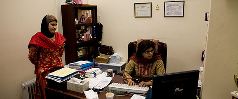 While her assistant brings steaming cups of chai to the men in the waiting waiting room, Roohi also helps other women in the neighborhood launch their own businesses. Photo by Nicole Tung.