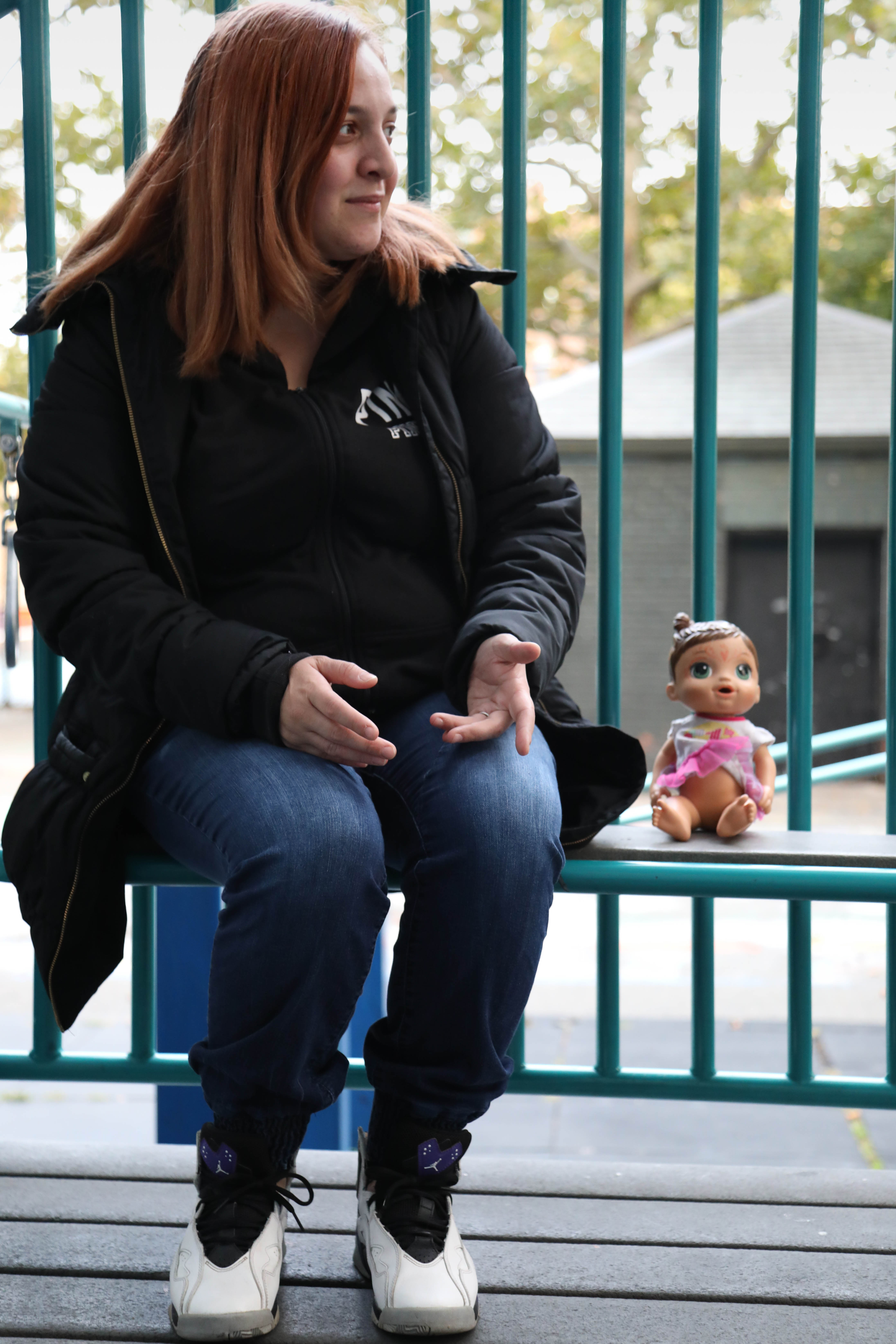 Brooke at the park with her daughter's doll 